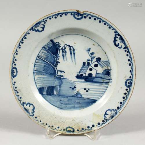 A DELFT TIN GLAZED BLUE AND WHITE PLATE painted with a house...