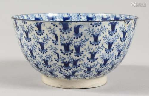 A 19TH CENTURY BLUE AND WHITE BOWL, painted all over with a ...