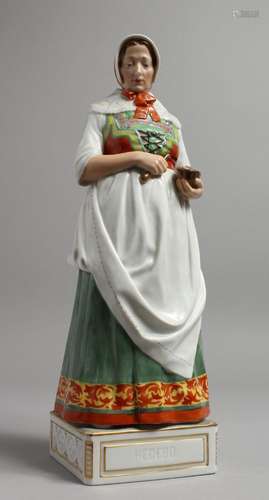 A LARGE COPENHAGEN PORCELAIN FIGURE OF A WOMAN holding a pes...