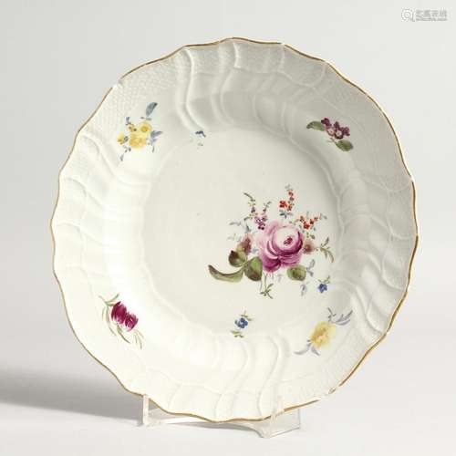 A 19TH CENTURY MEISSEN CIRCULAR PLATE with gilt waved border...