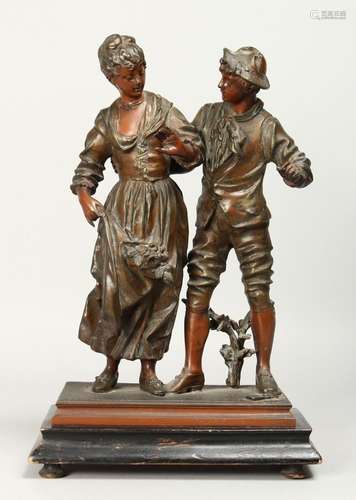 A 19TH CENTURY CONTINENTAL SPELTER GROUP OF A YOUNG LADY AND...