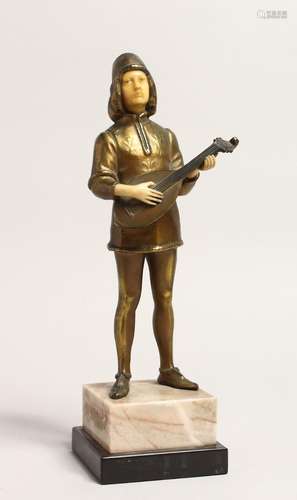 AN ART DECO GILT BRONZE AND BONE YOUNG MAN playing a mandoli...