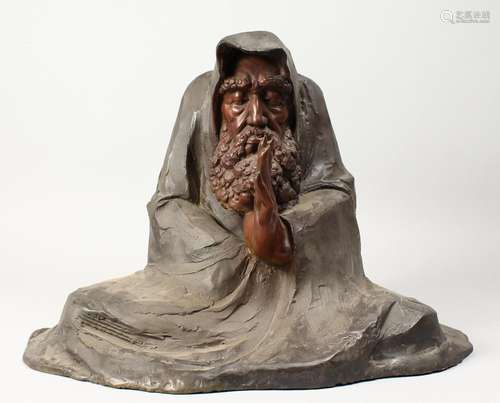 A BRONZE FIGURE OF A MAN meditating. 17ins long.