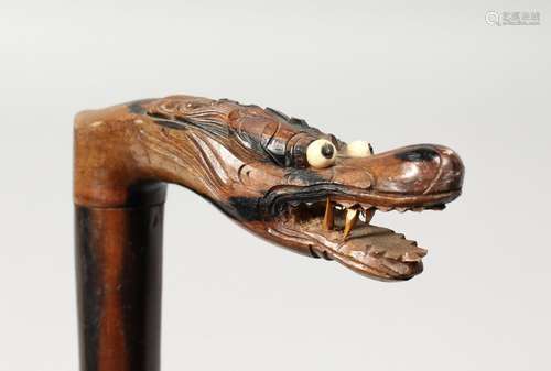 A CHINESE CARVED DRAGON HANDLE WALKING STICK. 34ins long.