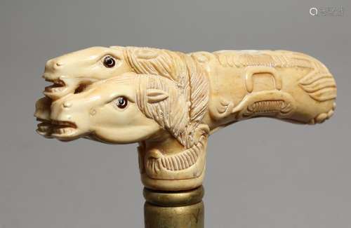 A WALKING STICK with bone handle, THREE HORSE'S HEADS.