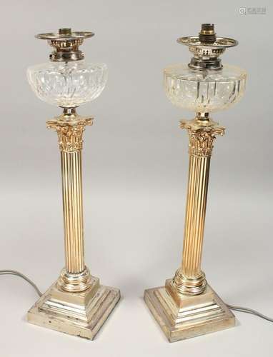 A GOOD PAIR OF CORINTHIAN COLUMN SILVER PLATED OIL LAMPS, ea...