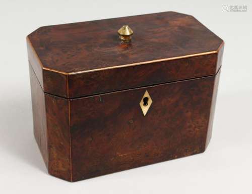 A GEORGE III AMBOYNA TEA CADDY, the hinged lid enclosing two...