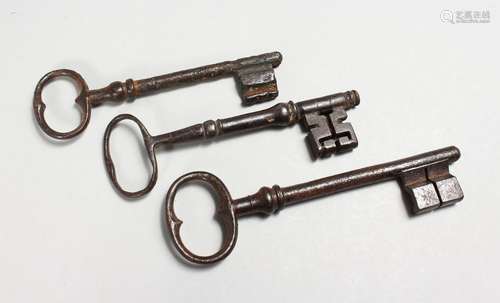 THREE 18TH / 19TH CENTURY CAST IRON KEYS. Largest: 6.25ins l...