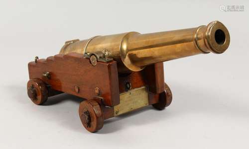 A HISTORICAL WOOD AND BRASS CANNON, made from the wood and b...