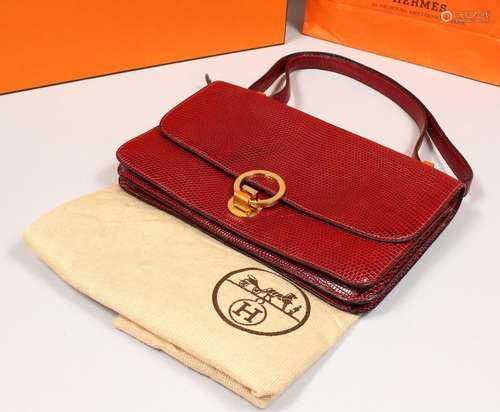 A HERMES BURGUNDY HANDBAG with dust bag and original box.