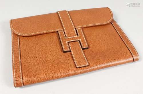 A BROWN LEATHER CLUTCH BAG. 11ins x 7.5ins.