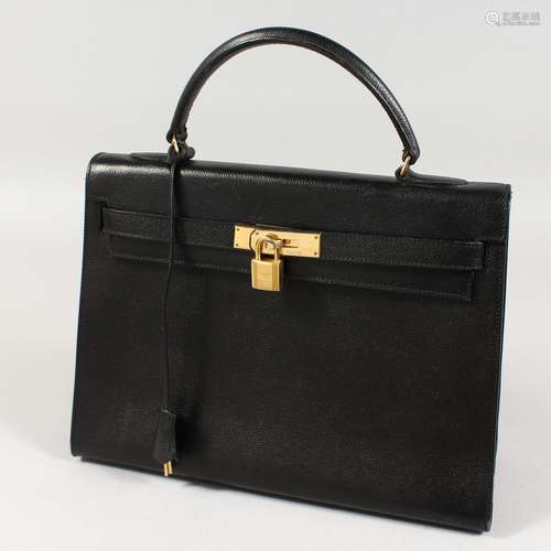 A BLACK LEATHER HANDBAG. 12ins x 9ins.