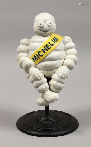 A CAST IRON MICHELIN MAN on a stand. 11ins high.