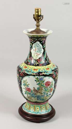 A CHINESE PORCELAIN LAMP with panels of flowers and birds on...