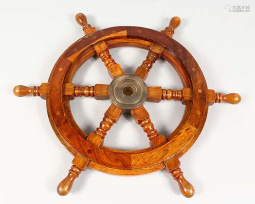 A WOODEN SHIP'S WHEEL. 12ins diameter.