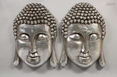 A PAIR OF SILVER WALL BUDDHAS. 22ins long.