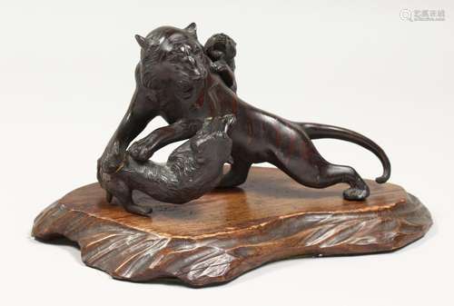 JAPANESE BRONZE TIGERS on a wooden base. 8ins long.