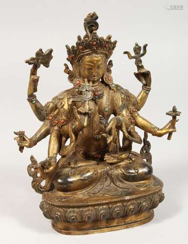 A CHINESE GILT BRONZE DEITY with eight arms. 8.5ins high.