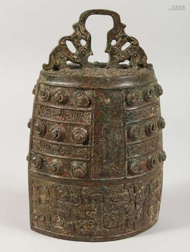 AN ARCHAIC BRONZE BELL. 11ins high.