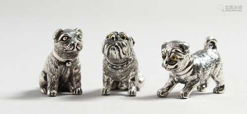 THREE CAST SILVER DOGS.