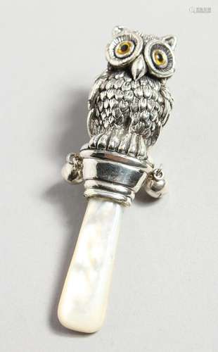 A SILVER AND MOTHER-OF-PEARL OWL RATTLE.