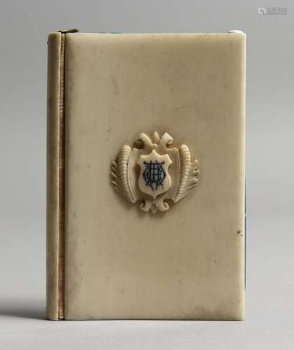 AN IVORY NOTEBOOK with crest. 4ins x 2.75ins.