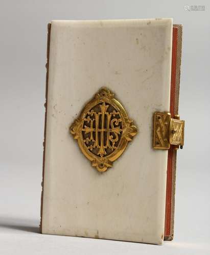 AN IVORY AND GILT MOUNTED PRAYER BOOK. 3.75ins x 2.5ins.