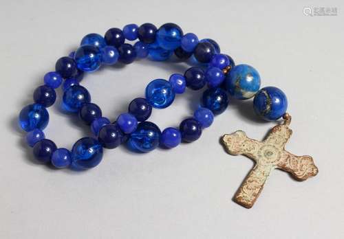 A ROMAN CAST IRON CROSS on a blue bead necklace.