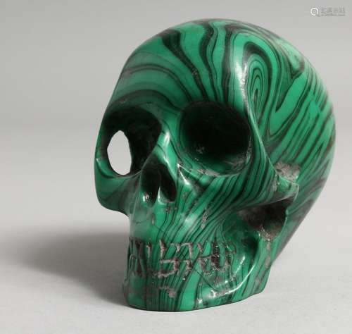 A CARVED MALACHITE SKULL. 4ins.