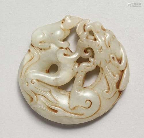 A CARVED JADE DRAGON ROUNDEL. 2ins.