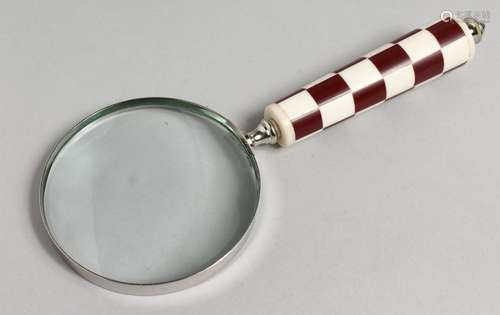 A NOVELTY MAGNIFYING GLASS with chequered handle.