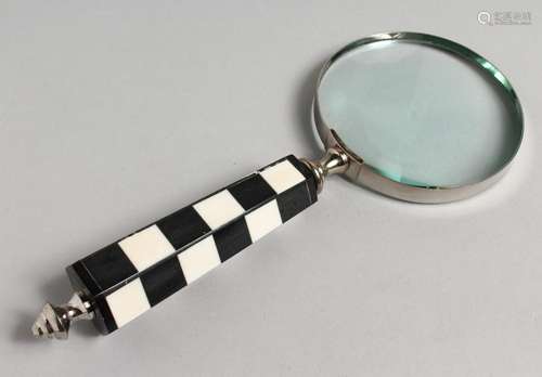 A NOVELTY MAGNIFYING GLASS with chequered handle.