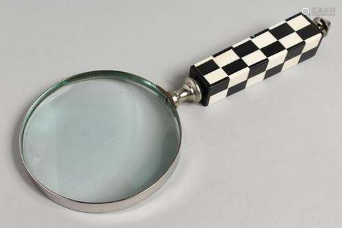 A NOVELTY MAGNIFYING GLASS with chequered handle.