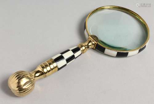 A NOVELTY MAGNIFYING GLASS with chequered and gilt handle.