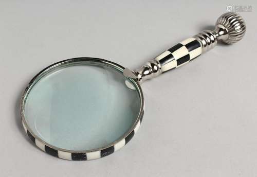 A NOVELTY MAGNIFYING GLASS with chequered and chrome handle.