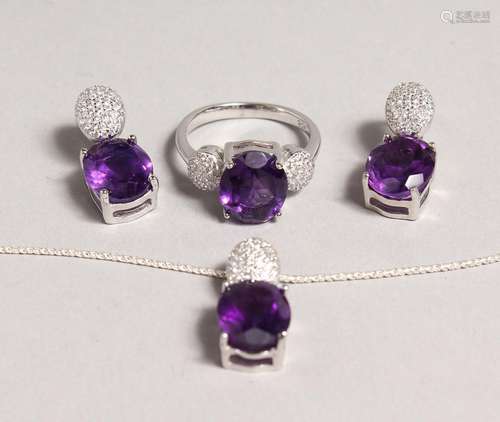 A SILVER AMETHYST SET RING and EARRINGS.