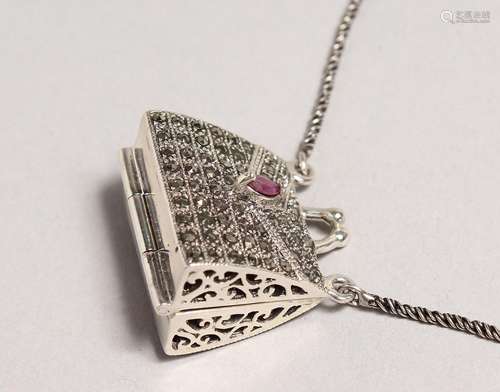 A SILVER MARCASITE RUBY SET HANDBAG LOCKET AND CHAIN.