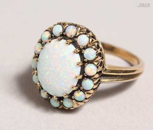 A 9CT GOLD OPAL CLUSTER RING.