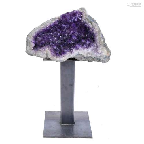 LARGE AMETHYST GEODE ON A PEDESTAL.