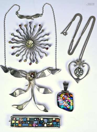 A collection of silver and white metal pendants