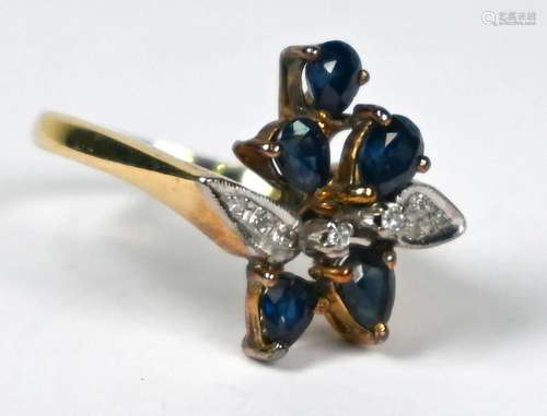 A continental dark blue sapphire and diamond flower