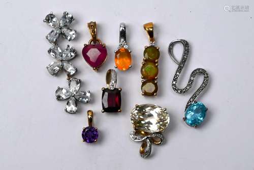 Eight various semi-precious gem set pendants