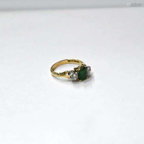 A three stone emerald and diamond ring