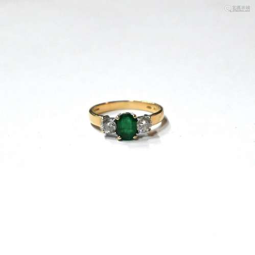 A three-stone emerald and diamond ring