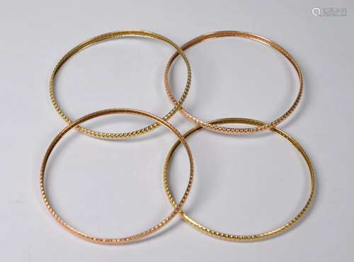 Four 14ct yellow and rose gold bangles