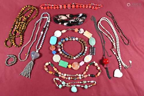 A collection of hardstone and glass necklaces