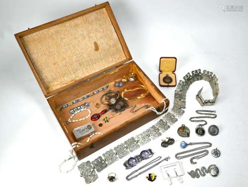 A wooden box containing a quantity of costume jewellery