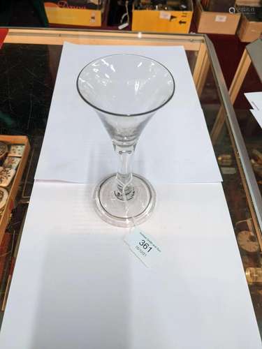 An antique cordial glass with flared conical bowl and