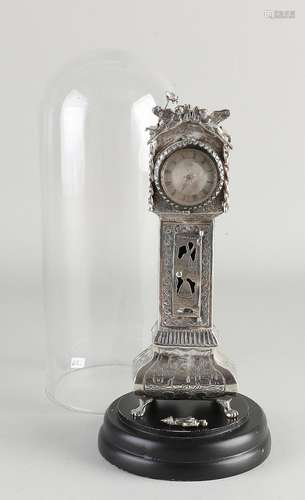 Silver standing watch under bell jar