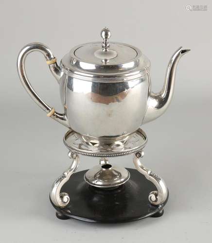 Silver teapot on stove